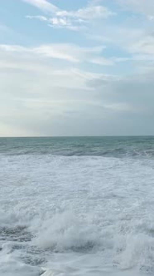 Vertical Video Aerial Perspective of Rough Mediterranean Seas With Crashing Waves and White Foam