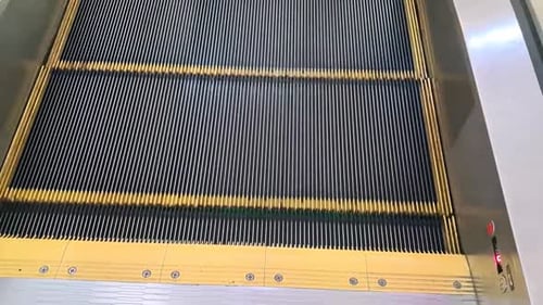 Close Up of Moving Escalator in Urban Setting