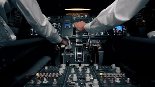 close-up hand of the pilot captain presses the buttons on the control panel to start the engine
