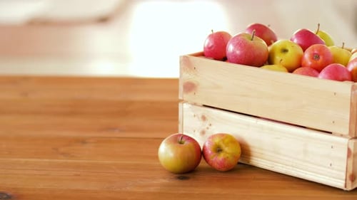 Ripe Apples in Wooden Crate on Table