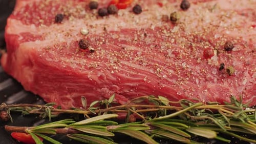 Close Up of Seasoned Raw Steak with Rosemary