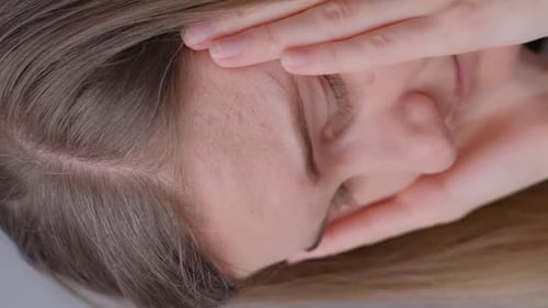 Young Woman Resting Hand on Face, Close Up