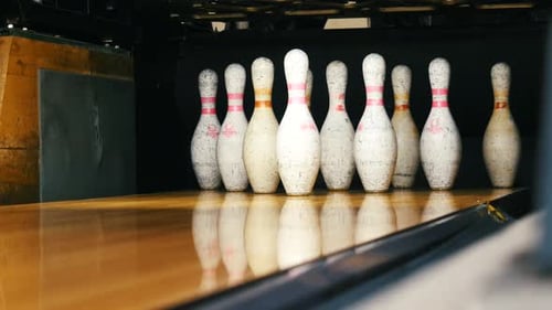 Bowling Ball Knocking Down Pins in Bowling Alley