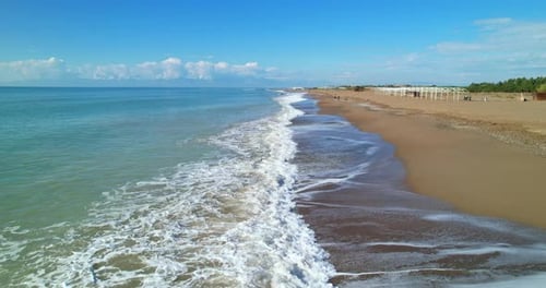 Sea Waves Foaming on the Sandy Shore