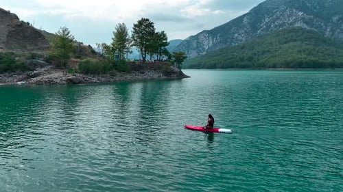 Aerial View Paddleboarding Journey Through Clear Blue Ocean Waters