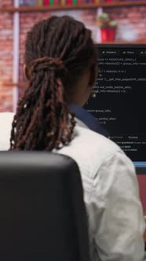 Focused Coder Types at Computer in Office Setting