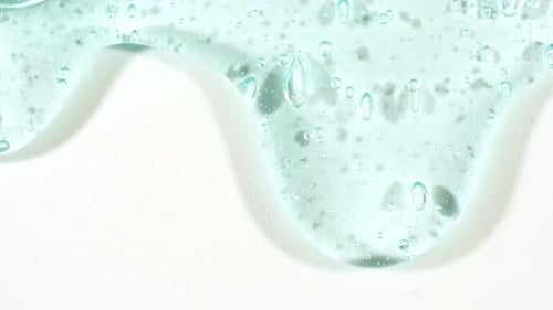 Cosmetic Gel Fluid With Molecule Bubbles Flowing On The Plain White Background Liquid Cream Gel