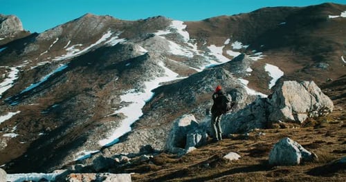 Hiker Tourist Puts Trekking Backpack After Rest on Mountain Adventure at Spring