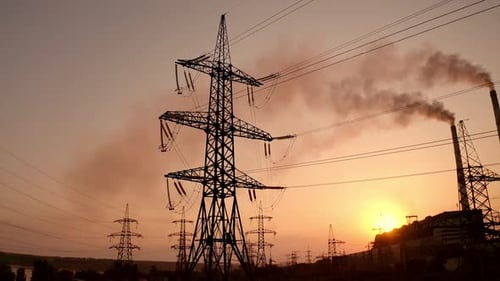 Electrical Towers and Industrial Plant at Sunset