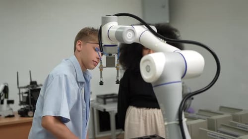 Diverse schoolkids working on robotic technologies at STEM educational class.