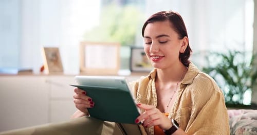 Woman Using Tablet Device at Home on Couch