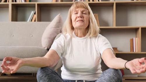 Senior Woman Meditating Peacefully Indoors