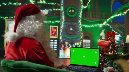 Santa Claus Looking at Letter Received From Kids on Green Screen Laptop