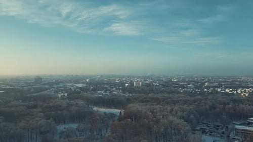 Drone Flying Above City. Panoramic View Of Park And City In Winter. Cinematic Drone Winter Footage