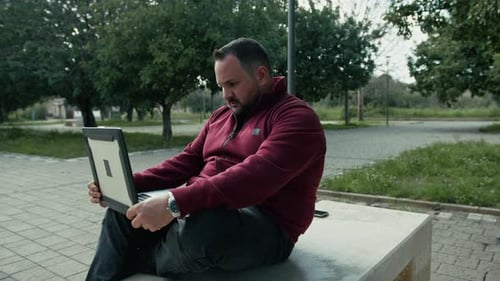 Man Doing His Digital Job From The City Park