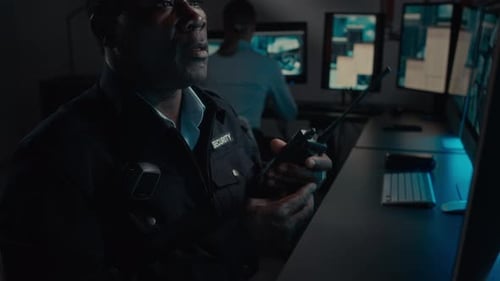 Black Security Guard Reporting Abnormal Customer Behaviour on Radio