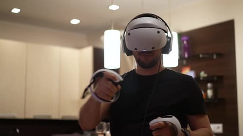 Man Exploring Virtual Reality with Headset and Controllers