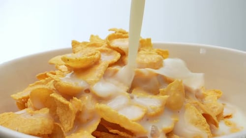Milk Being Poured Over a Bowl of Cereal