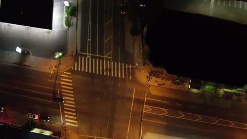 Aerial flight over a street and residential area during the night