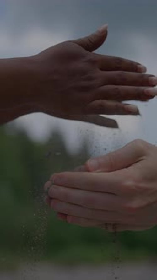 Unity Through Nature A Symbolic Embrace of Hands and Sand Celebrating Our Shared Connection