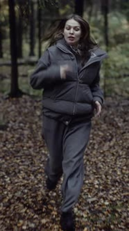Frightened Woman Running in Autumn Forest