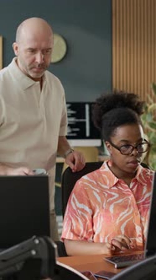 Coworkers Collaborating at Computer in Modern Office