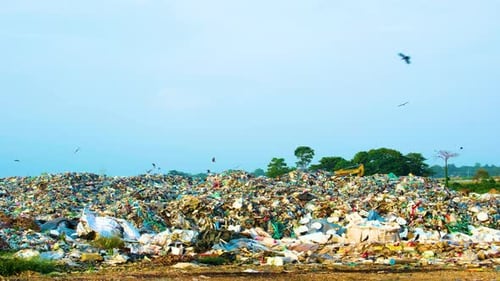 Large Garbage Dump Landscape Under Blue Sky