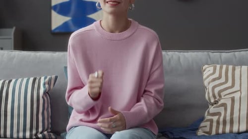 Woman Gesturing While Speaking On Couch