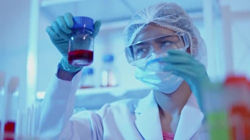 Researcher Handling Fluid Sample in a Laboratory