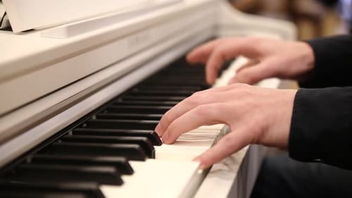 Man playing classical white piano, close-up video