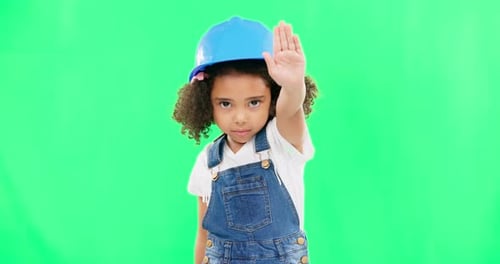 Stop, construction and face of a child on a green screen isolated on a studio background