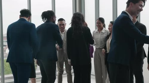 In a Meeting Professionals Seal a Deal with a Handshake