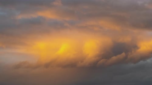 Time Lapse of Fast Moving Stormy Clouds on Dark Yellow Sky at Sunset