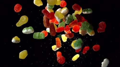 Colorful Candies Falling Against a Black Background
