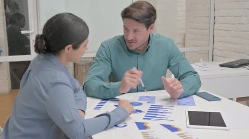 Business Professionals Discussing Data at Office Workplace