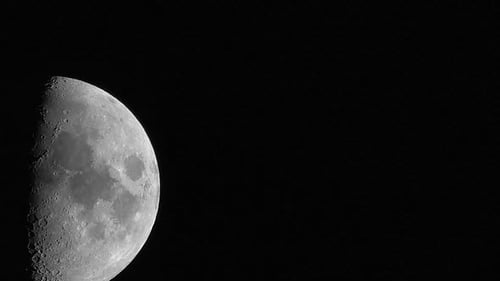 A bright waxing gibbous moon in amazing detail moves across the screen in this stunning time lapse