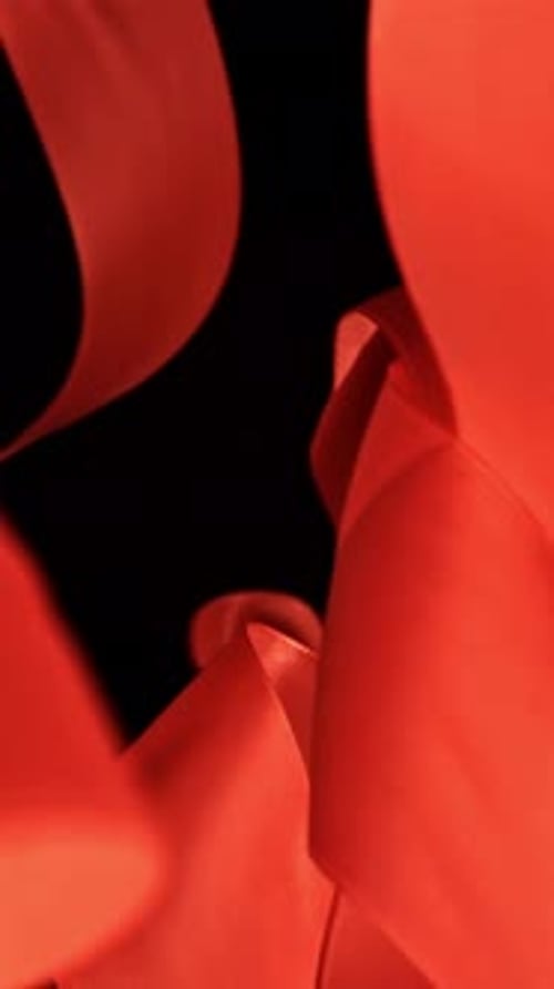 A Red Ribbon Flies on a Black Background Filmed on a Highspeed Camera at 1000 Fps