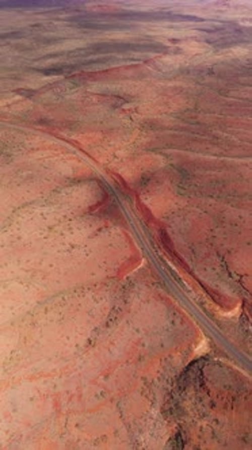 Aerial view of desert landscape and winding road, Australia.