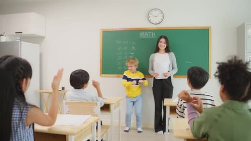 Group of student learn with teacher in classroom at elementary school.