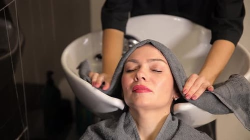 Woman Getting Hair Towel Wrapped at Salon