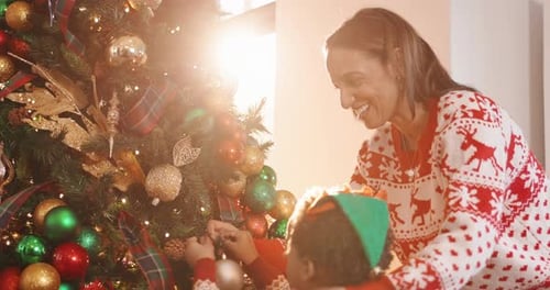 Mom, son and tree with decoration for Christmas, festive celebration or holiday tradition