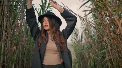 Girl Standing High Grass in Black Hat Close Up