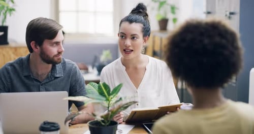 4k video footage of a group of young businesspeople having a meeting in a modern office