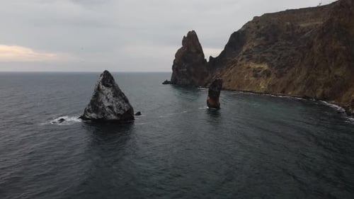 Aerial View on Calm Azure Sea and Volcanic Rocky Shores Small Waves on Water Surface Nature Summer