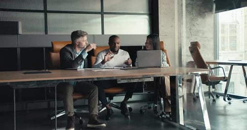 A View of the Work of a Successful Multiracial Trio Successful Company in the Office Sits at the