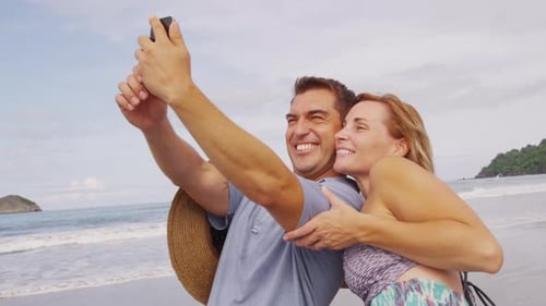 Couple Taking Photo Together at Beach, Costa Rica. on Red Epic