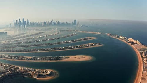 Panoramic wide angle view of Plam Jumeirah in Dubai UAE during sunrise with clear blue sky
