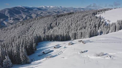 Winter Wonderland Showcasing Snowy Mountain Peaks and a Cozy Cabin Nestled in a Frosty Forest