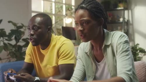 Man and Woman Playing Video Games at Home