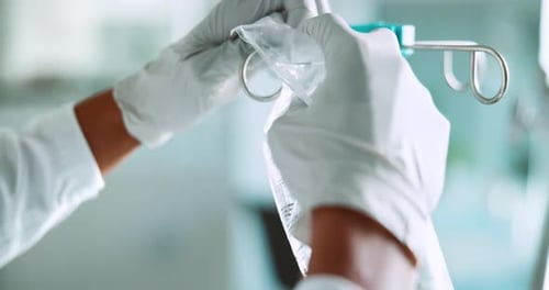 IV, drip and person hands with medical, liquid and wellness fluid for hydration at hospital